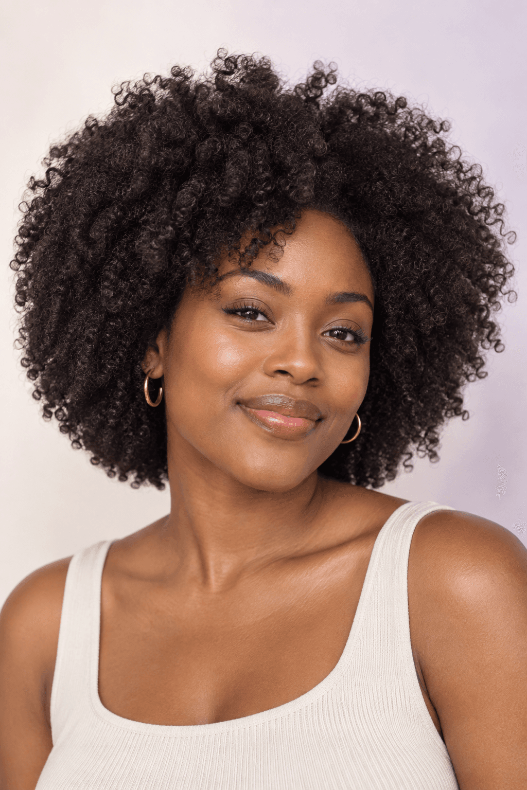 Portrait with a full, defined natural coil hairstyle